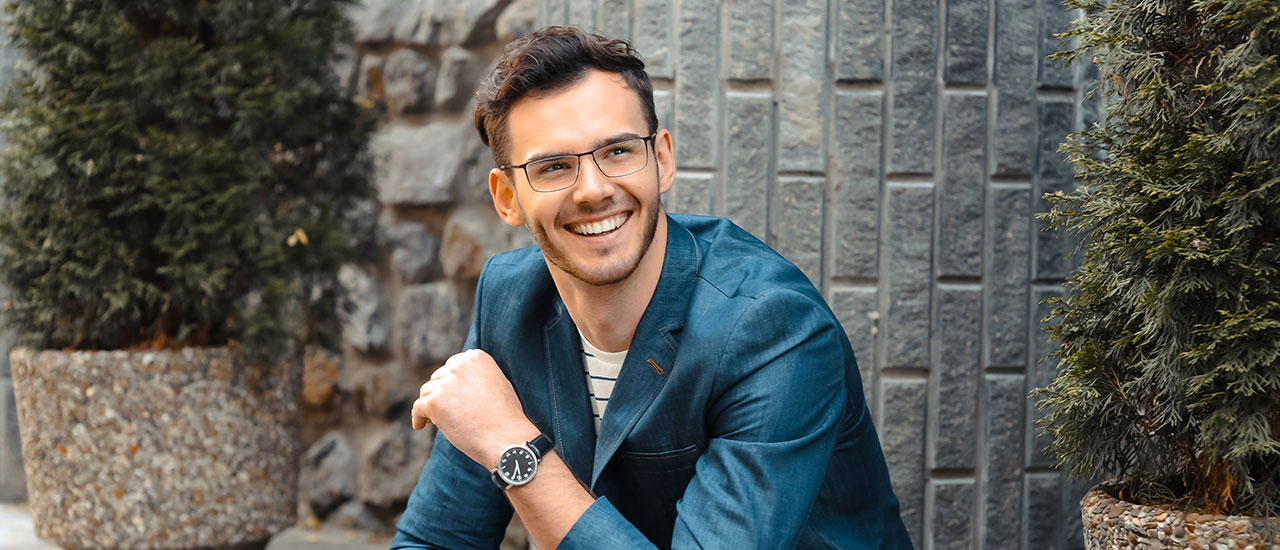 man wearing glasses sitting outside